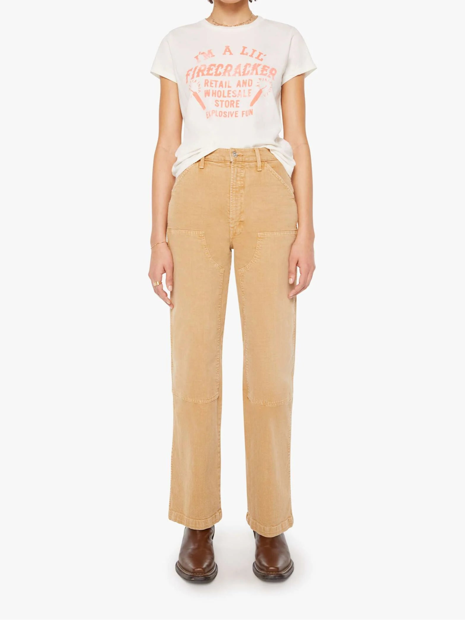 Person wearing a white t-shirt with red text and beige pants on a white background, full body view