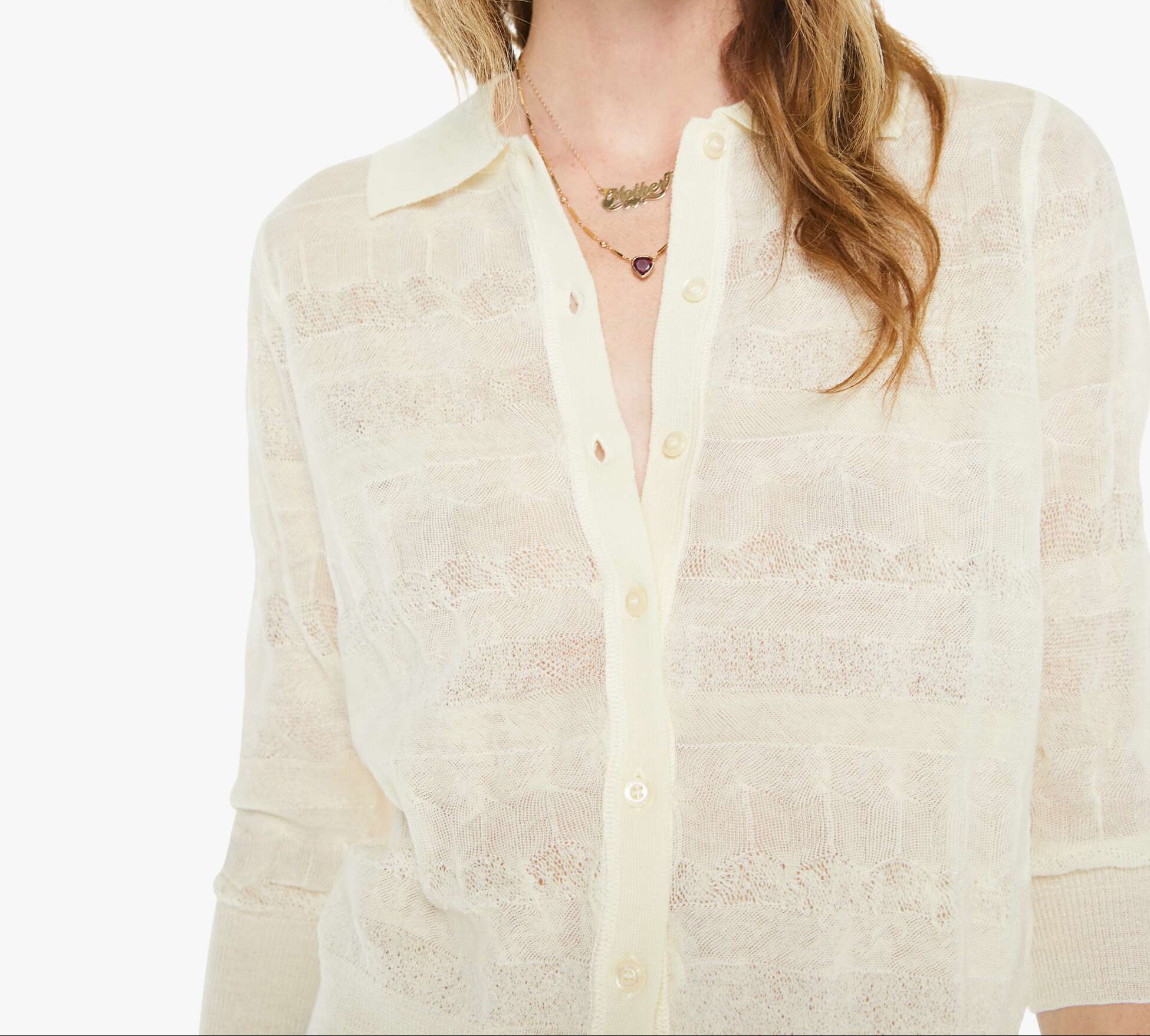 Woman wearing a light-colored shirt and sunglasses on a white background