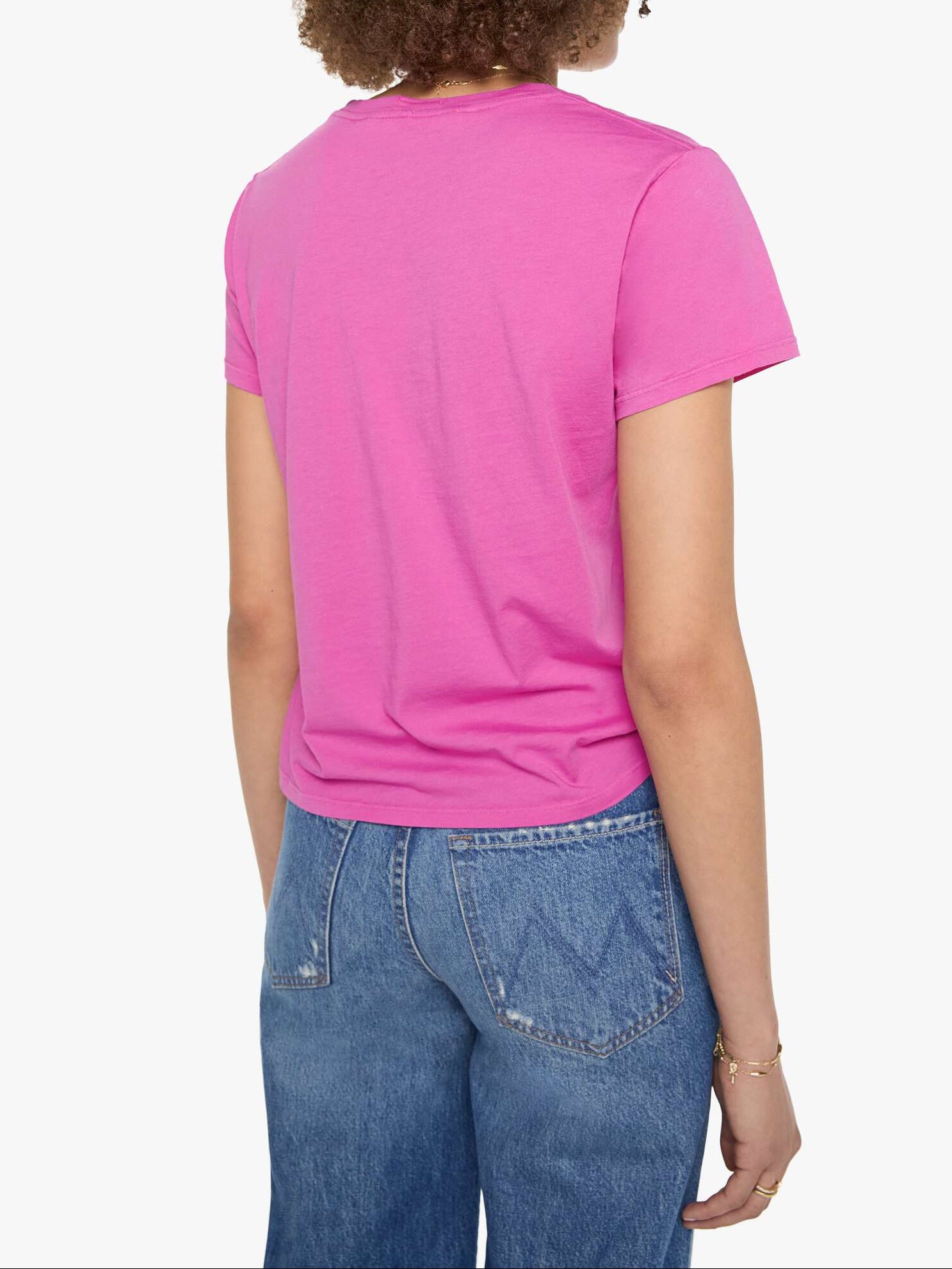 A person shown from the back wearing a bright pink short-sleeve crew-neck t-shirt and blue jeans, against a plain light gray background.