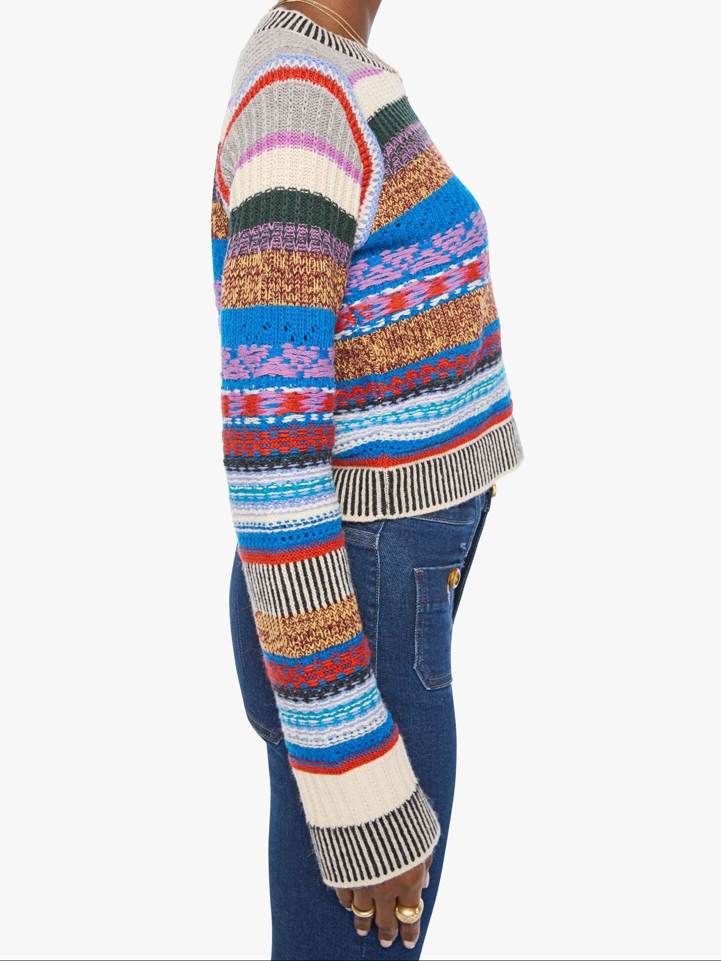 Person wearing a colorful patterned sweater on a white background