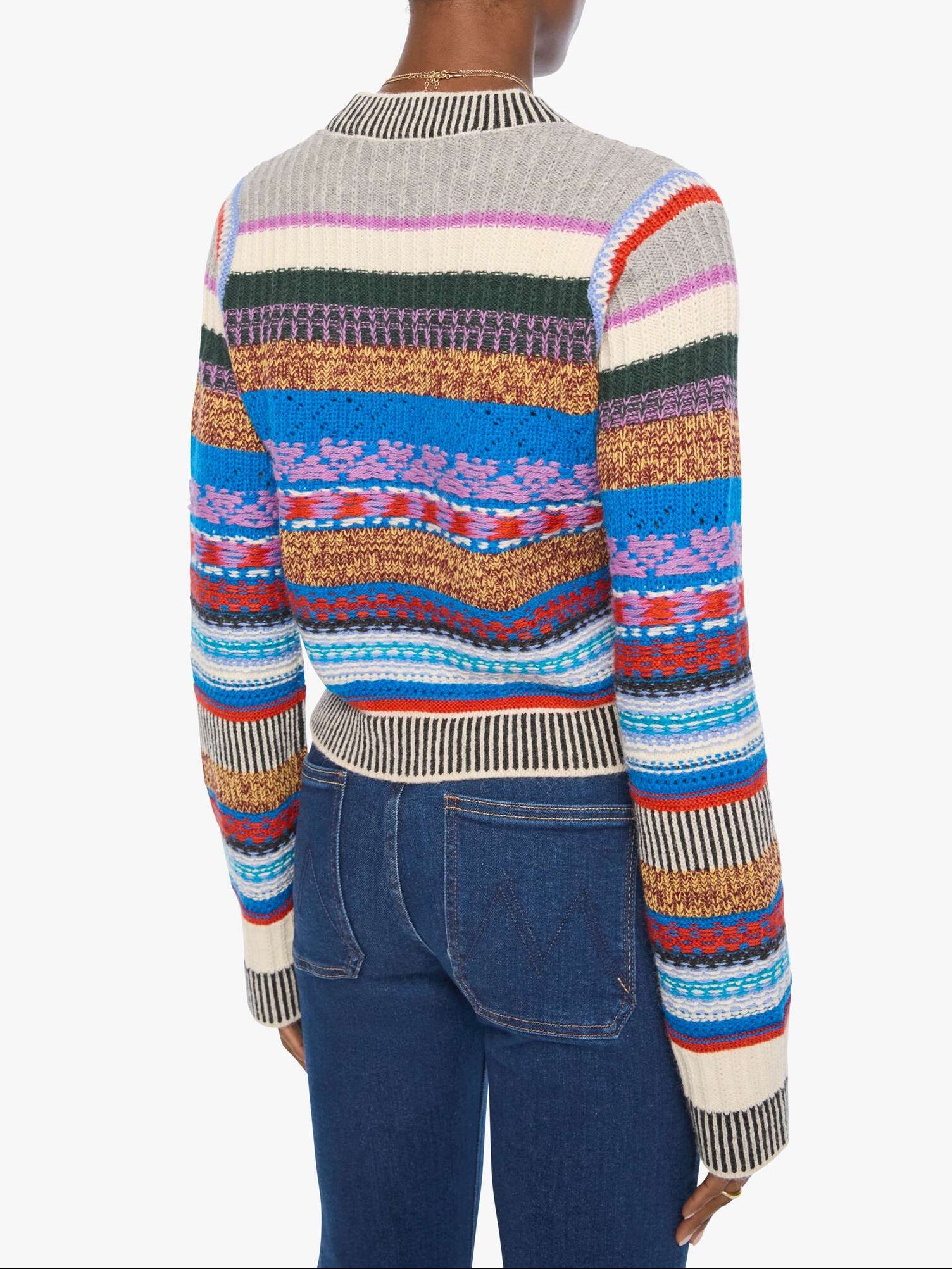 Person wearing a colorful striped sweater on a white background, back