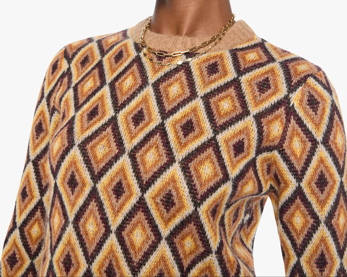 Woman wearing a patterned sweater and sunglasses on a white background