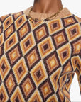 Woman wearing a patterned sweater and sunglasses on a white background