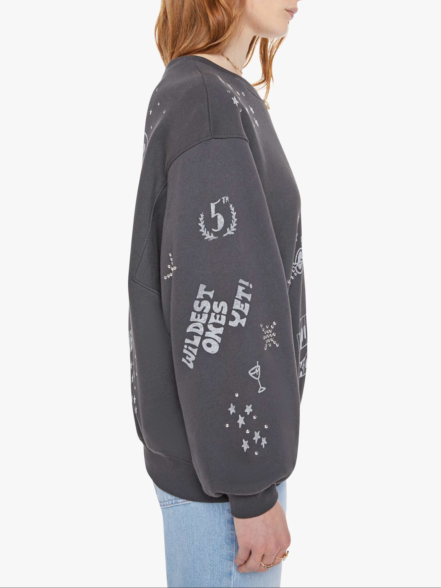 Person wearing a dark gray sweatshirt with text and graphics on a white background, side