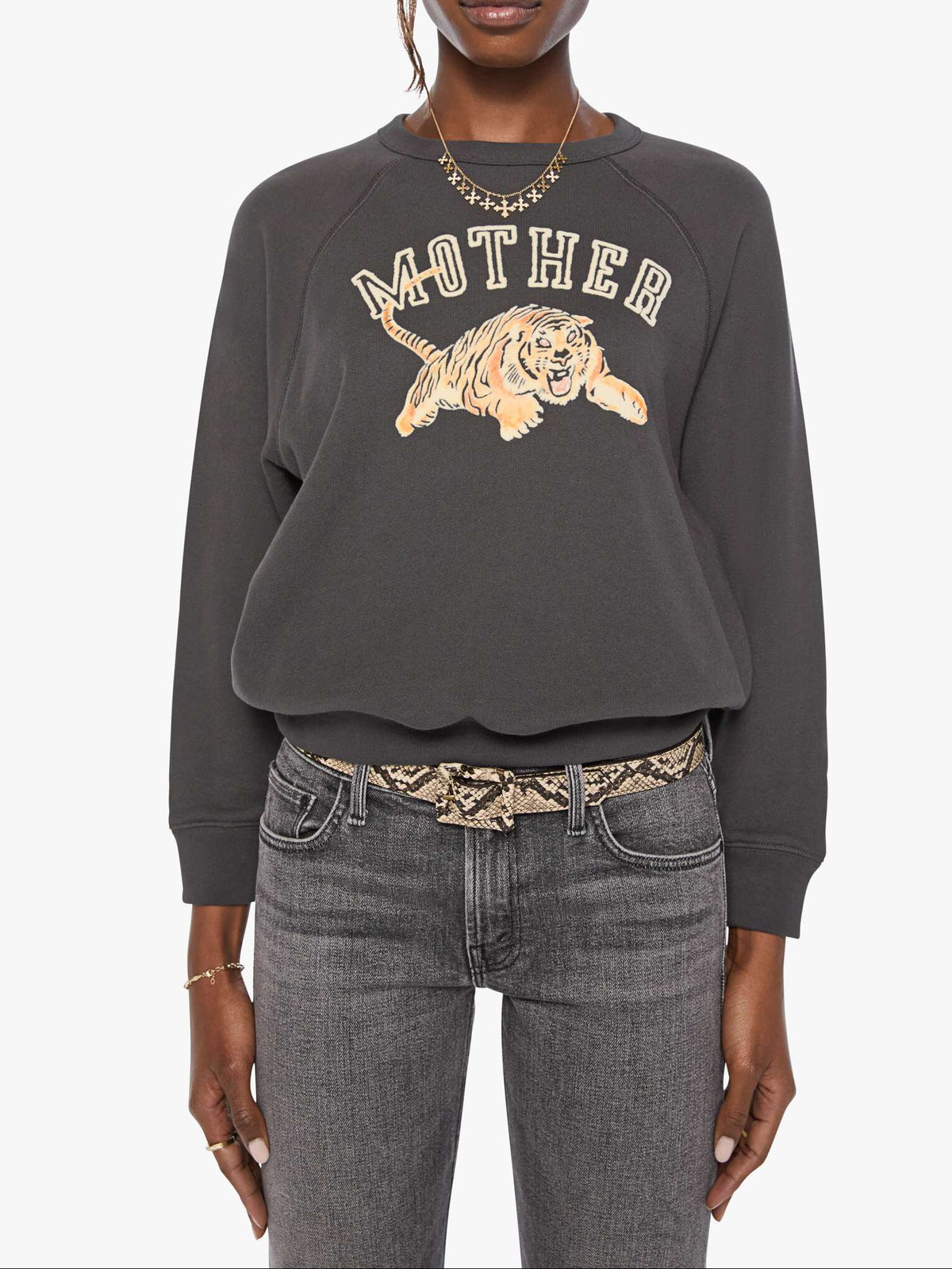 Person wearing a dark gray sweatshirt with a graphic design on a white background