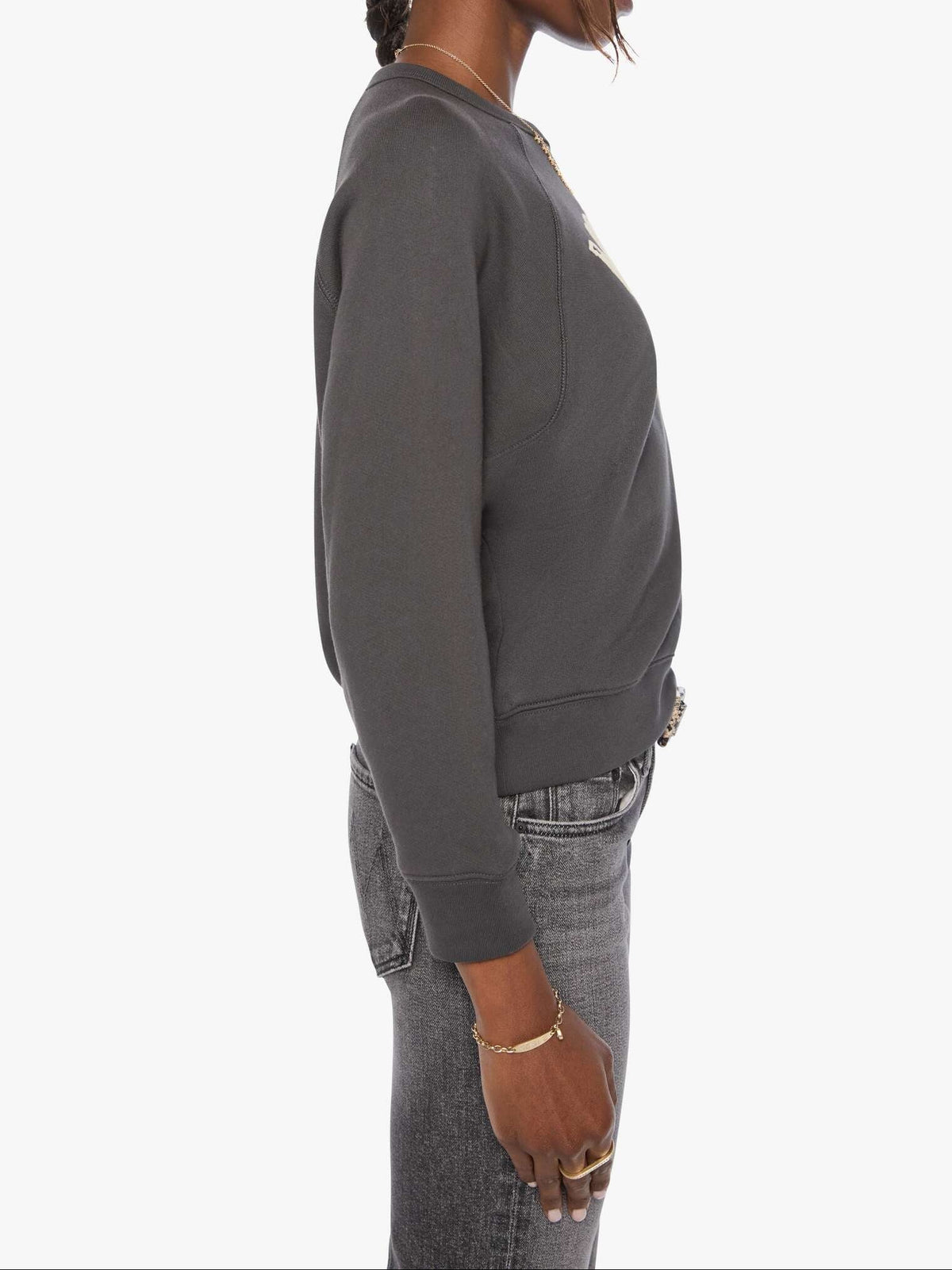 Woman wearing a gray sweatshirt and jeans on a white background