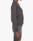 Woman wearing a gray sweatshirt and jeans on a white background