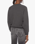 Person wearing a dark gray sweatshirt and jeans on a white background