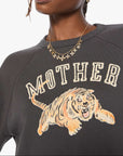 Woman wearing a dark gray sweatshirt with a tiger graphic and 'MOTHER' text on a white background