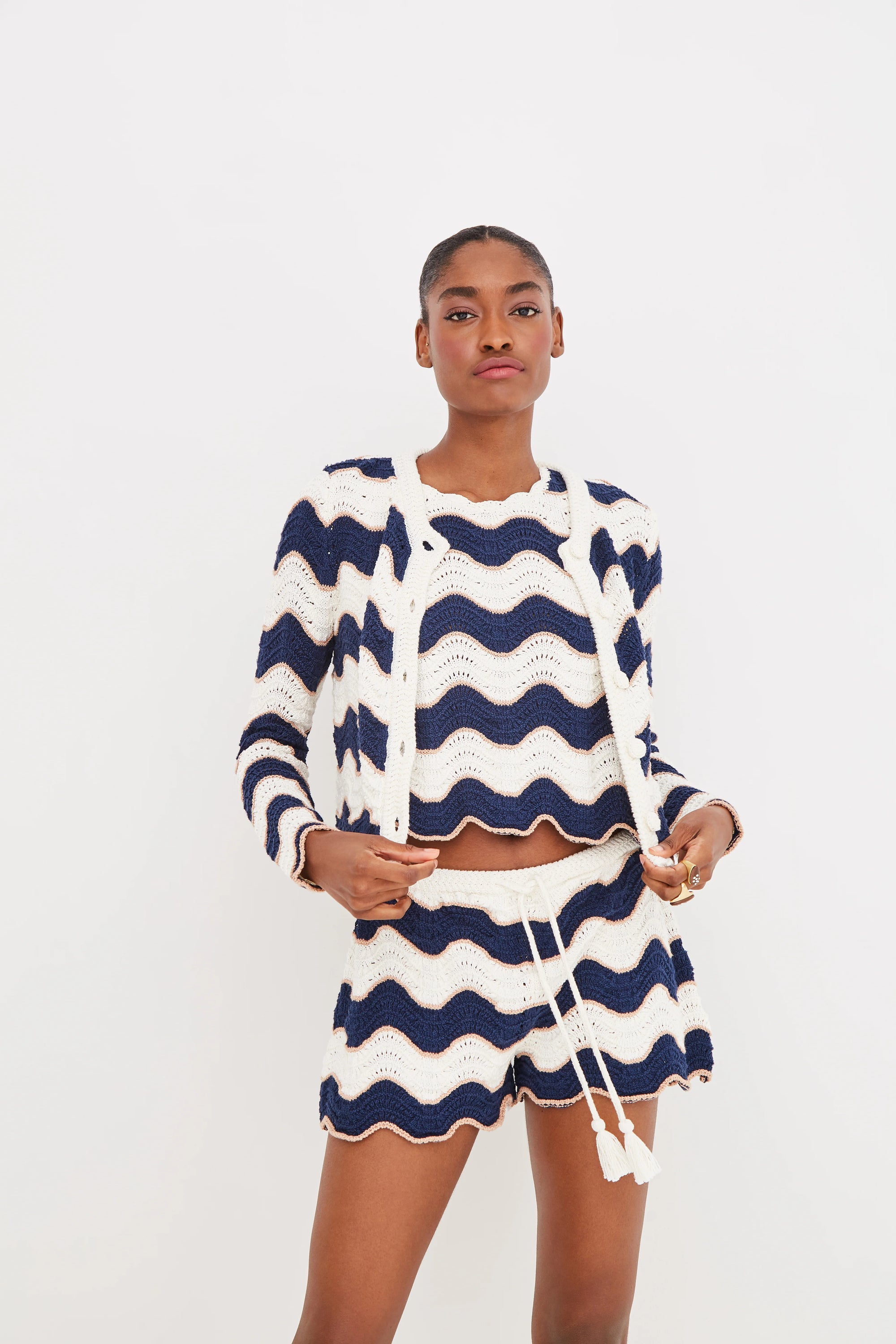 Woman wearing a blue and white striped outfit on a light gray background