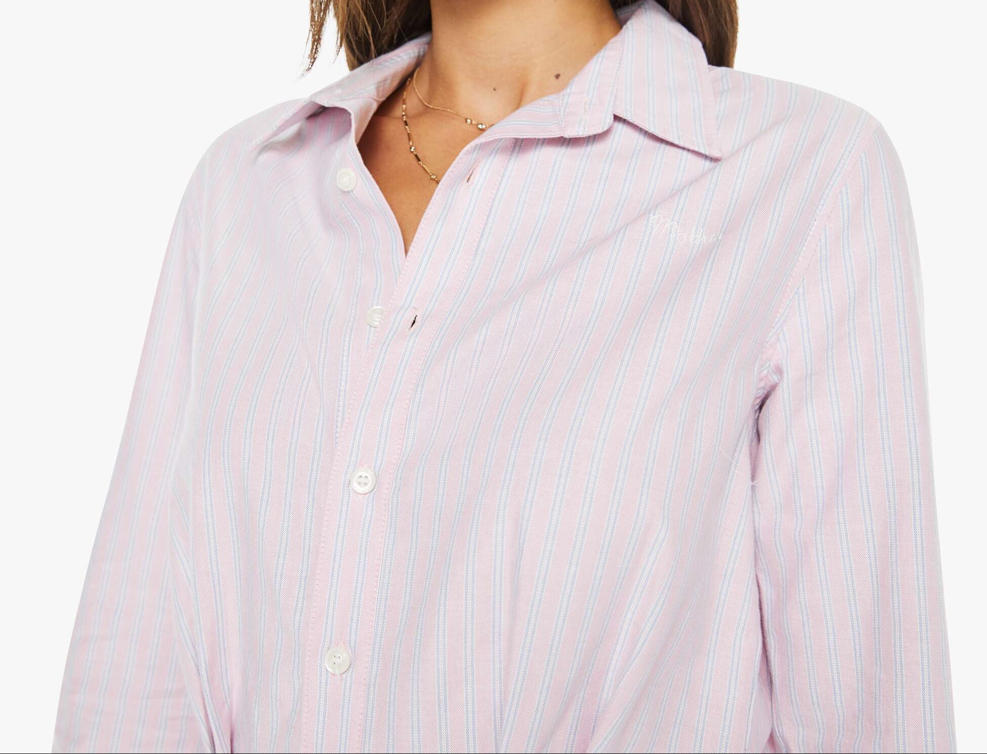 Woman wearing a light pink shirt with a plain background