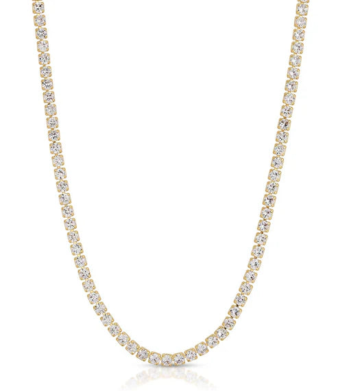 Gold necklace with clear stones on a white background