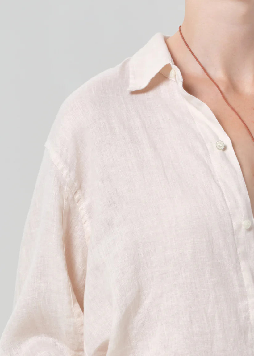 Close-up of a cream shirt on a gray background