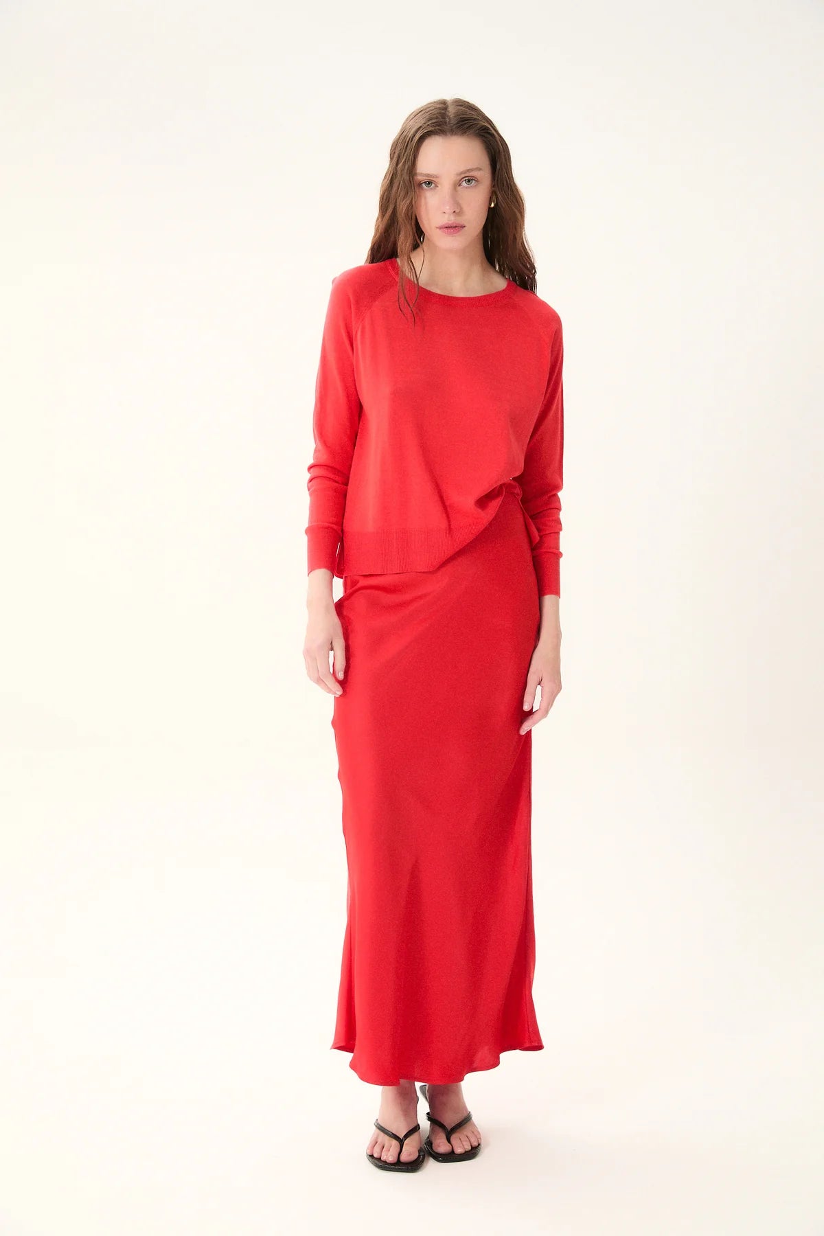 Woman wearing a red outfit on a white background