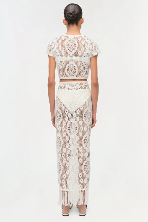 Person wearing a white lace outfit on a white background
