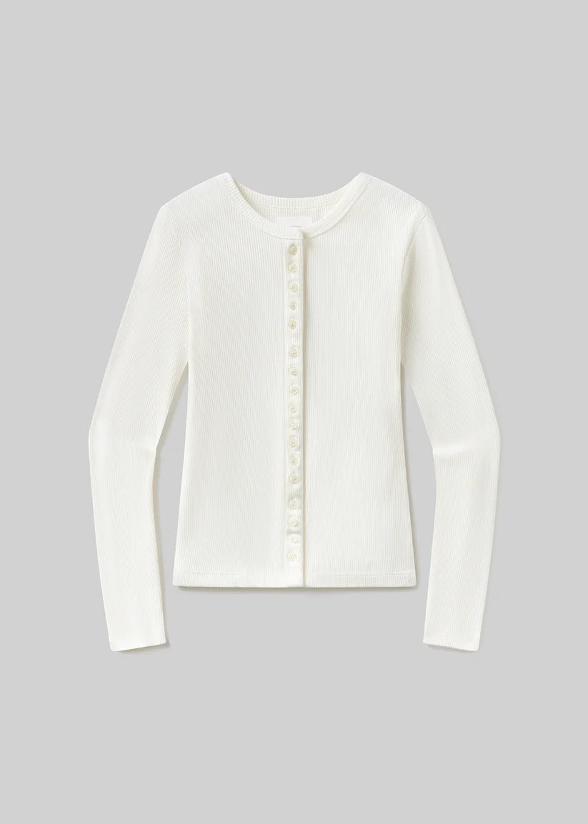 An off-white long-sleeve knit top with a round neckline and a decorative vertical row of pearl-like buttons down the center front, displayed on a neutral gray background.