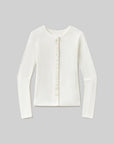 An off-white long-sleeve knit top with a round neckline and a decorative vertical row of pearl-like buttons down the center front, displayed on a neutral gray background.