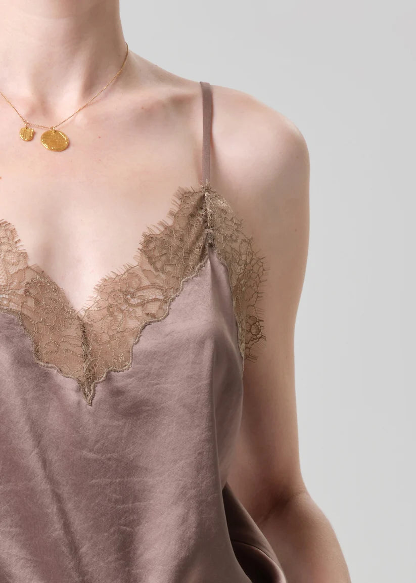 Silk slip with lace detailing on a neutral background