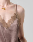 Silk slip with lace detailing on a neutral background
