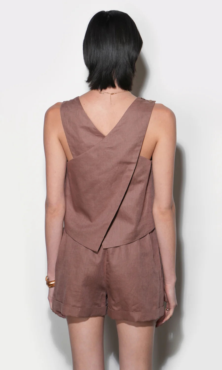 Brown sleeveless top and shorts outfit on a plain background