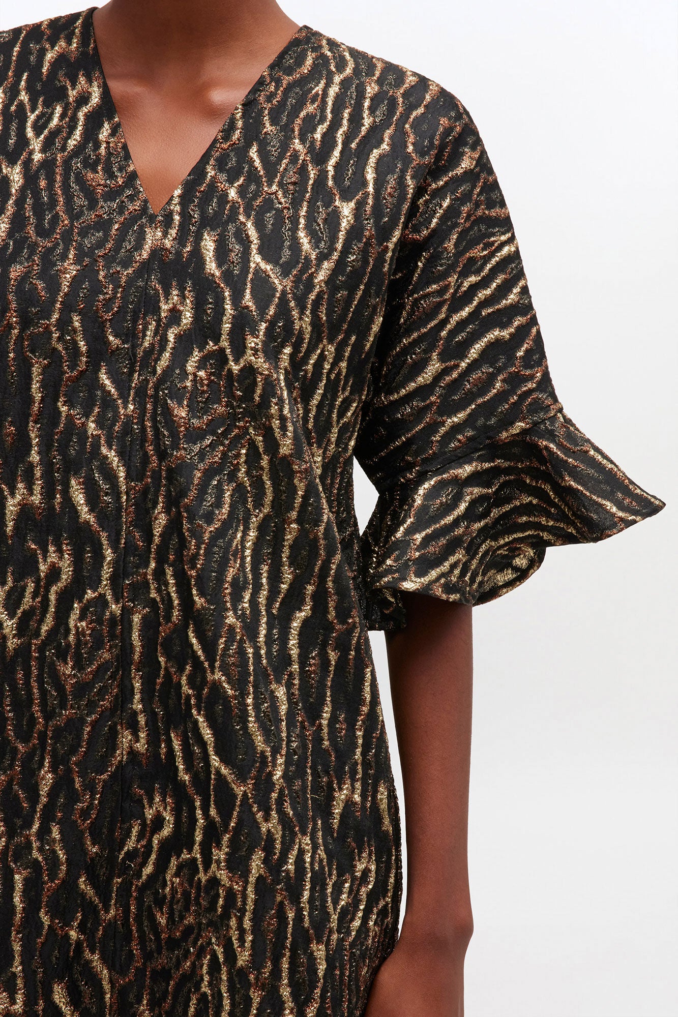 Animal print dress with ruffled sleeves on a white background