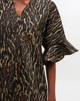 Animal print dress with ruffled sleeves on a white background