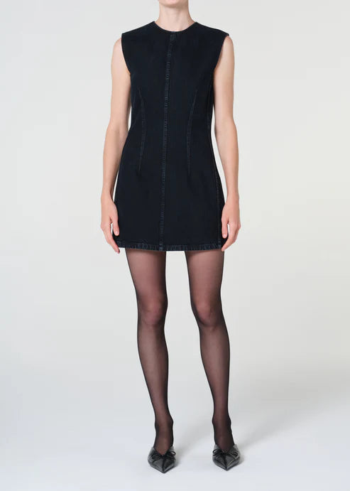 Person wearing a black sleeveless dress on a white background