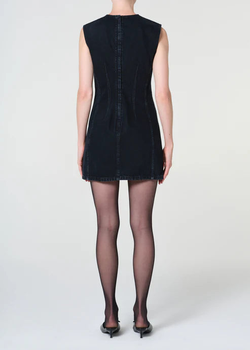 Black denim dress worn by a person on a white background
