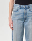 Light blue jeans worn by a person on a white background