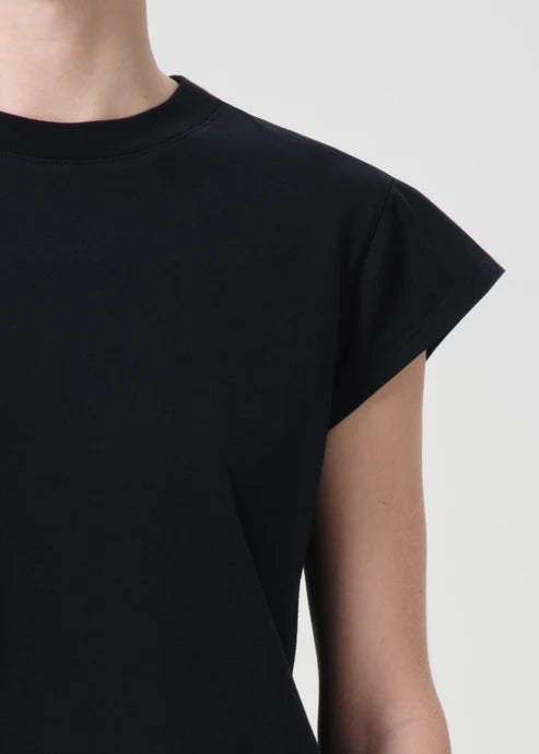 Black dress with cap sleeves on a neutral background