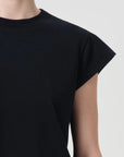 Black dress with cap sleeves on a neutral background