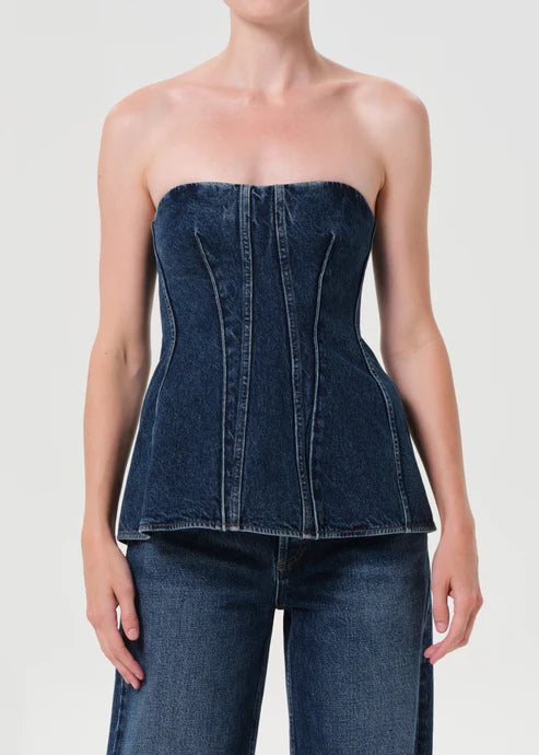 Denim strapless top worn by a model on a plain background