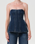 Denim strapless top worn by a model on a plain background