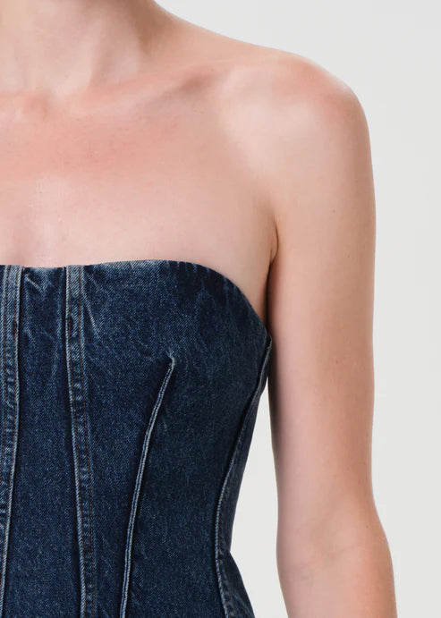 Denim strapless dress on a plain background