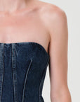 Denim strapless dress on a plain background