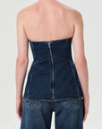Denim strapless top worn by a person on a plain background