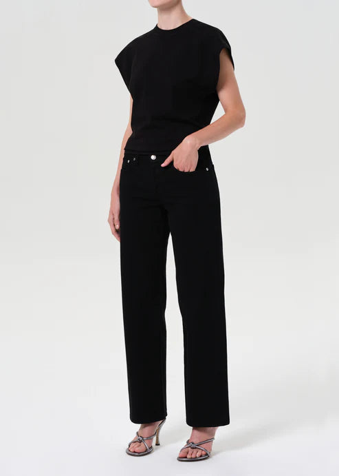 Person wearing a black outfit with a plain white background