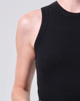 Black sleeveless top worn by a person on a light gray background