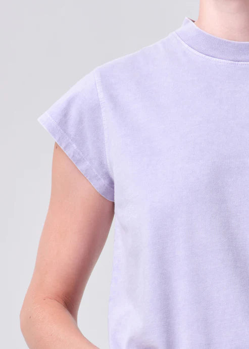 Light purple t-shirt worn by a person on a plain background