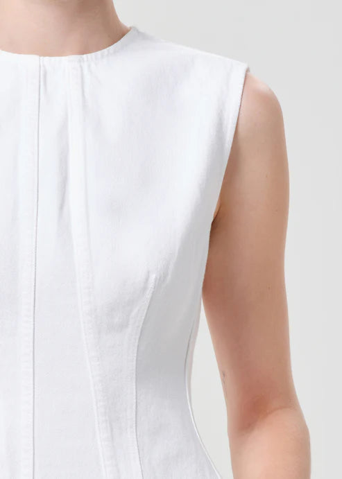 model wearing white denim top with a white background