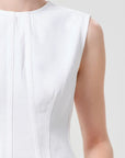 model wearing white denim top with a white background