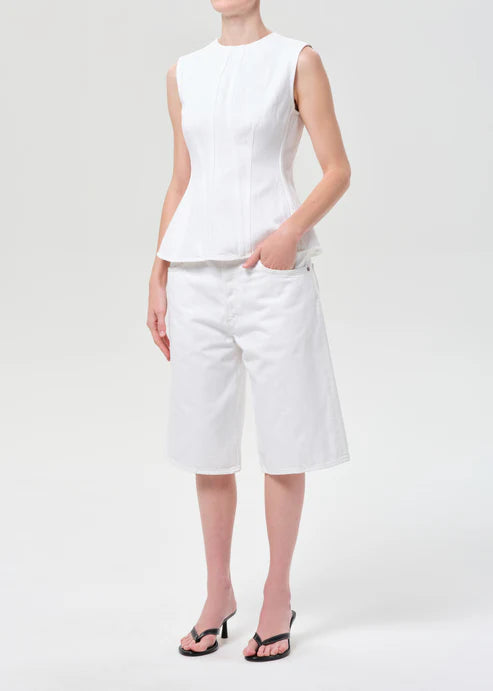 model wearing white denim top and shorts with a white background