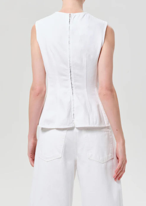 model wearing white denim top with a white background back view