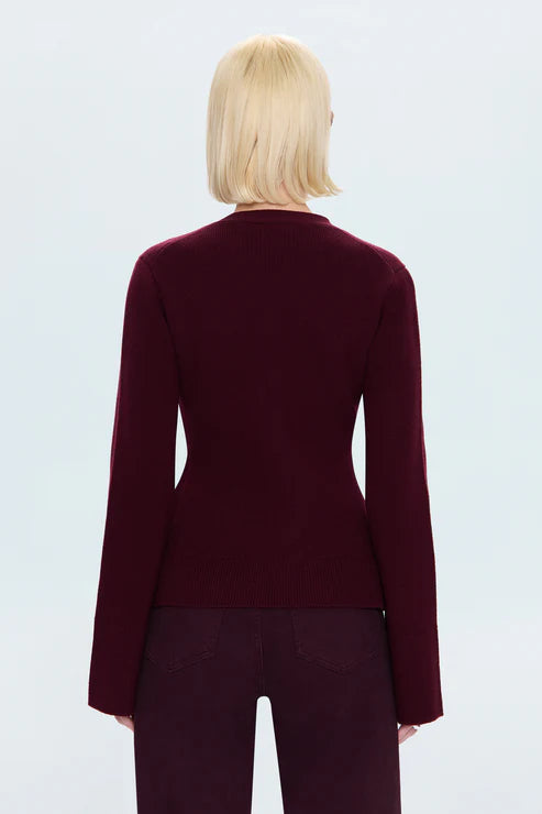 Woman wearing a burgundy cardigan on a white background back