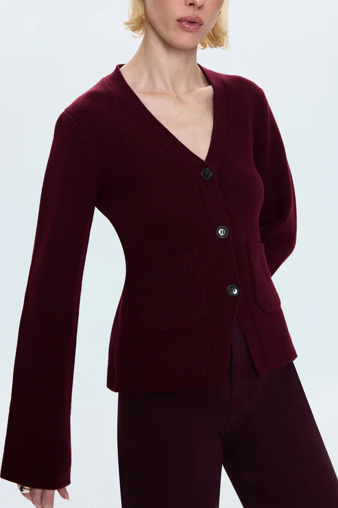Woman wearing a burgundy cardigan on a white background side