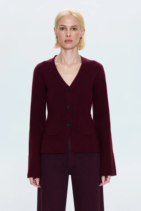 Woman wearing a burgundy cardigan on a white background