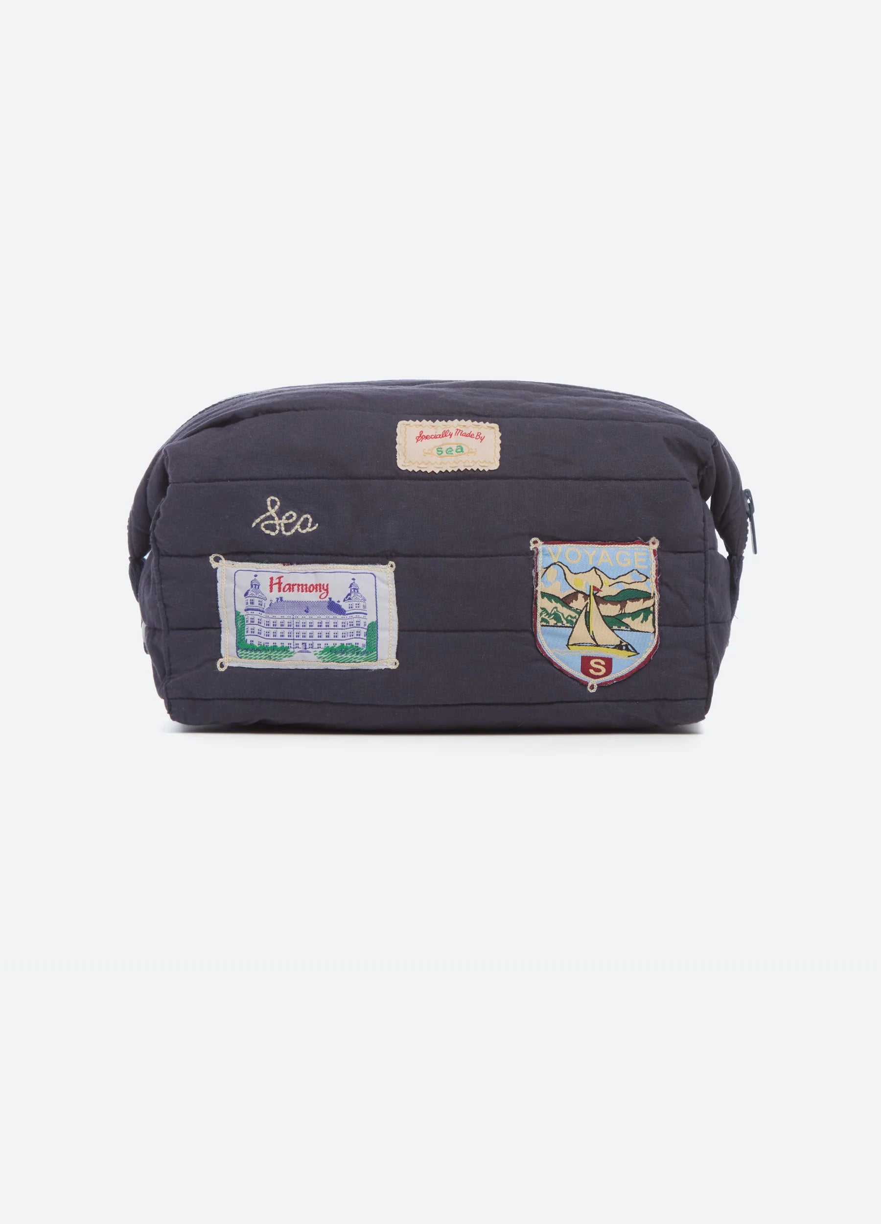 navy cosmetic bag with patches on white background