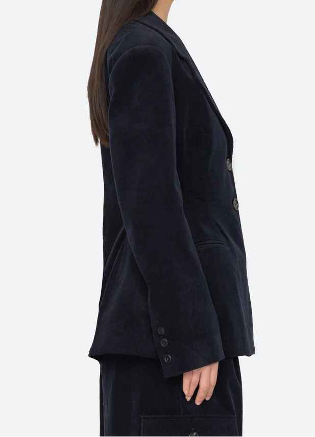 Woman wearing a dark blue blazer on a white background