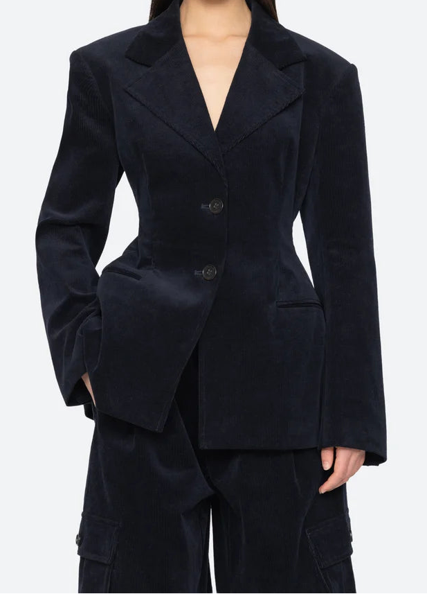 Woman wearing a dark blue suit on a white background