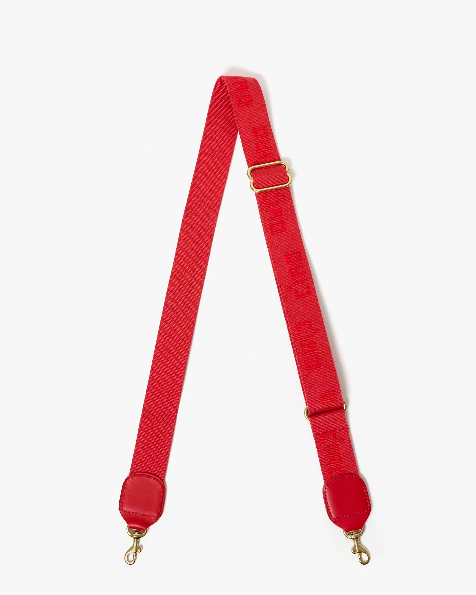 Red bag strap with gold hardware on a white background